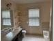 Bathroom with a single sink, tub/shower combination, and shelving at 6420 Phillips Pl, Lithonia, GA 30058