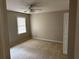 Neutral bedroom with one window, ceiling fan, and plush carpeting at 6420 Phillips Pl, Lithonia, GA 30058