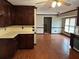 Bright kitchen with wooden cabinets, hardwood floors and stainless steel dishwasher at 6420 Phillips Pl, Lithonia, GA 30058