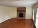 Bright living room with hardwood floors, large windows, and a brick fireplace at 6420 Phillips Pl, Lithonia, GA 30058