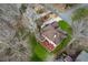 Aerial view of a home with a red back deck surrounded by bare trees and lush green grass at 2353 Habersham Sw Dr, Marietta, GA 30064