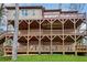 A tiered wooden deck supports a two-story home and leads to a staircase and backyard at 2353 Habersham Sw Dr, Marietta, GA 30064