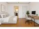 Bright bedroom with a modern desk setup, hardwood floors, and neutral decor at 2353 Habersham Sw Dr, Marietta, GA 30064
