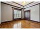 Bedroom with tray ceilings, hardwood floors, dark trim, plantation shutters at 2353 Habersham Sw Dr, Marietta, GA 30064