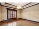 A cozy bedroom with hardwood floors, a chandelier, and a large window with wooden shutters at 2353 Habersham Sw Dr, Marietta, GA 30064