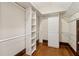 Organized walk-in closet with shelving, closet rods, and natural wood floors for a custom and functional space at 2353 Habersham Sw Dr, Marietta, GA 30064