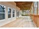 Large covered deck with wood flooring and railings, offering ample space for outdoor enjoyment at 2353 Habersham Sw Dr, Marietta, GA 30064
