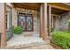 Close-up of impressive double front doors with brick entryway, pillars, and manicured bushes at 2353 Habersham Sw Dr, Marietta, GA 30064