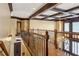 Elegant hallway with decorative railing, hardwood floors, coffered ceiling, and ornate chandelier at 2353 Habersham Sw Dr, Marietta, GA 30064