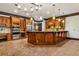 A gourmet kitchen with an oversized island, custom cabinets, stainless steel appliances, and beautiful brick flooring at 2353 Habersham Sw Dr, Marietta, GA 30064