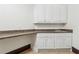 Functional laundry room with white cabinets, ample counter space, and a stainless steel sink at 2353 Habersham Sw Dr, Marietta, GA 30064