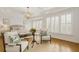 Light-filled living room featuring white walls, hardwood floors, and large windows at 2353 Habersham Sw Dr, Marietta, GA 30064