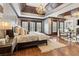Spacious main bedroom featuring hardwood floors, tray ceilings, and plantation shutters at 2353 Habersham Sw Dr, Marietta, GA 30064