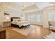 Elegant main bedroom featuring hardwood floors, plantation shutters, and stylish furnishings at 2353 Habersham Sw Dr, Marietta, GA 30064
