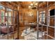 Sophisticated home office featuring wood paneling, coffered ceiling, and a cowhide rug at 2353 Habersham Sw Dr, Marietta, GA 30064