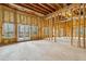 Spacious unfinished room with exposed wood framing, windows, and French doors at 2353 Habersham Sw Dr, Marietta, GA 30064