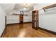 Spacious walk-in closet with hardwood floors, custom shelving, and a stylish chandelier at 2353 Habersham Sw Dr, Marietta, GA 30064