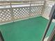 Open-air balcony space with white lattice railing and green indoor/outdoor carpet at 475 Mount Vernon Ne Hwy # C230, Sandy Springs, GA 30328