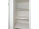 White storage closet with easily reachable shelves for organizing your personal belongings at 475 Mount Vernon Ne Hwy # C230, Sandy Springs, GA 30328