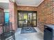 Inviting entryway with automatic doors, a Mount Vernon Village welcome mat, and a comfortable rocking chair at 475 Mount Vernon Ne Hwy # C230, Sandy Springs, GA 30328