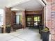 Building entrance with brick facade, automatic doors, and bench at 475 Mount Vernon Ne Hwy # C230, Sandy Springs, GA 30328