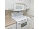 Efficient kitchen with white appliances and cabinets for an organized cooking space at 475 Mount Vernon Ne Hwy # C230, Sandy Springs, GA 30328