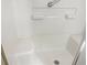 Accessible shower with built-in seating, grab bar, and tiled walls for a safe and comfortable experience at 475 Mount Vernon Ne Hwy # C230, Sandy Springs, GA 30328