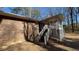 Back of home featuring a wooden stairway leading to an open-air porch at 533 Fayetteville Rd, Fairburn, GA 30213