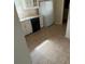 Functional kitchen featuring white cabinets, essential appliances, and durable tile flooring at 533 Fayetteville Rd, Fairburn, GA 30213
