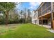 Beautiful backyard with an in-ground screened porch, white brick, and stairs to the yard at 4895 Lansbury Dr, Atlanta, GA 30342
