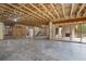 Large unfinished basement with open concept, fireplace, and sliding glass doors to the backyard at 4895 Lansbury Dr, Atlanta, GA 30342