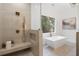 This bathroom boasts a soaking tub, large window and tiled shower with bench seating at 4895 Lansbury Dr, Atlanta, GA 30342