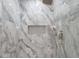 Modern shower features gray marble tile, a rainfall shower head, handheld sprayer and built-in niche at 4895 Lansbury Dr, Atlanta, GA 30342