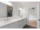 Sleek bathroom featuring a double sink vanity, modern mirrors and dark tiled flooring at 4895 Lansbury Dr, Atlanta, GA 30342