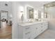Bright bathroom featuring double vanity, illuminated mirrors and a glass enclosed shower at 4895 Lansbury Dr, Atlanta, GA 30342