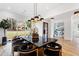 Charming dining room with hardwood floors, eye-catching lighting, and garden view windows at 4895 Lansbury Dr, Atlanta, GA 30342