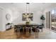 Elegant dining room with a modern light fixture and large windows at 4895 Lansbury Dr, Atlanta, GA 30342