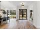 Welcoming home entryway featuring high ceilings, wood floors, and a modern chandelier at 4895 Lansbury Dr, Atlanta, GA 30342