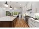 Bright kitchen featuring a large island with a sink, stainless steel appliances, and open floorplan at 4895 Lansbury Dr, Atlanta, GA 30342