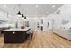 Spacious open-concept kitchen with hardwood floors, stainless steel appliances, large island, and modern pendant lighting at 4895 Lansbury Dr, Atlanta, GA 30342