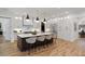 Open kitchen with a large center island, modern lighting, and white cabinetry at 4895 Lansbury Dr, Atlanta, GA 30342