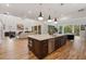 Spacious kitchen island with seating, stainless steel appliances, and an open floor plan to the living room at 4895 Lansbury Dr, Atlanta, GA 30342