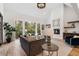 Open living room with vaulted ceilings, fireplace, and large windows with backyard views at 4895 Lansbury Dr, Atlanta, GA 30342