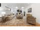 Cozy living room featuring skylights, hardwood floors, and comfortable, stylish furniture at 4895 Lansbury Dr, Atlanta, GA 30342