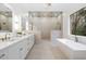 Luxurious main bathroom with double sinks, soaking tub, walk-in shower, and elegant fixtures at 4895 Lansbury Dr, Atlanta, GA 30342