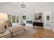 Primary bedroom featuring a fireplace, large windows, vaulted ceilings, and hardwood flooring at 4895 Lansbury Dr, Atlanta, GA 30342
