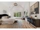 Bright and airy main bedroom with a fireplace, sitting area, vaulted ceilings, and large window at 4895 Lansbury Dr, Atlanta, GA 30342