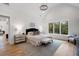Light-filled primary bedroom with vaulted ceilings, hardwood floors, a sitting area, and decorative lighting at 4895 Lansbury Dr, Atlanta, GA 30342