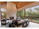 Inviting screened-in porch with a brick fireplace, comfortable seating, and views of the backyard at 4895 Lansbury Dr, Atlanta, GA 30342