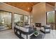 Covered brick patio with fireplace, wood ceiling, large sliding glass doors, and outdoor seating at 4895 Lansbury Dr, Atlanta, GA 30342